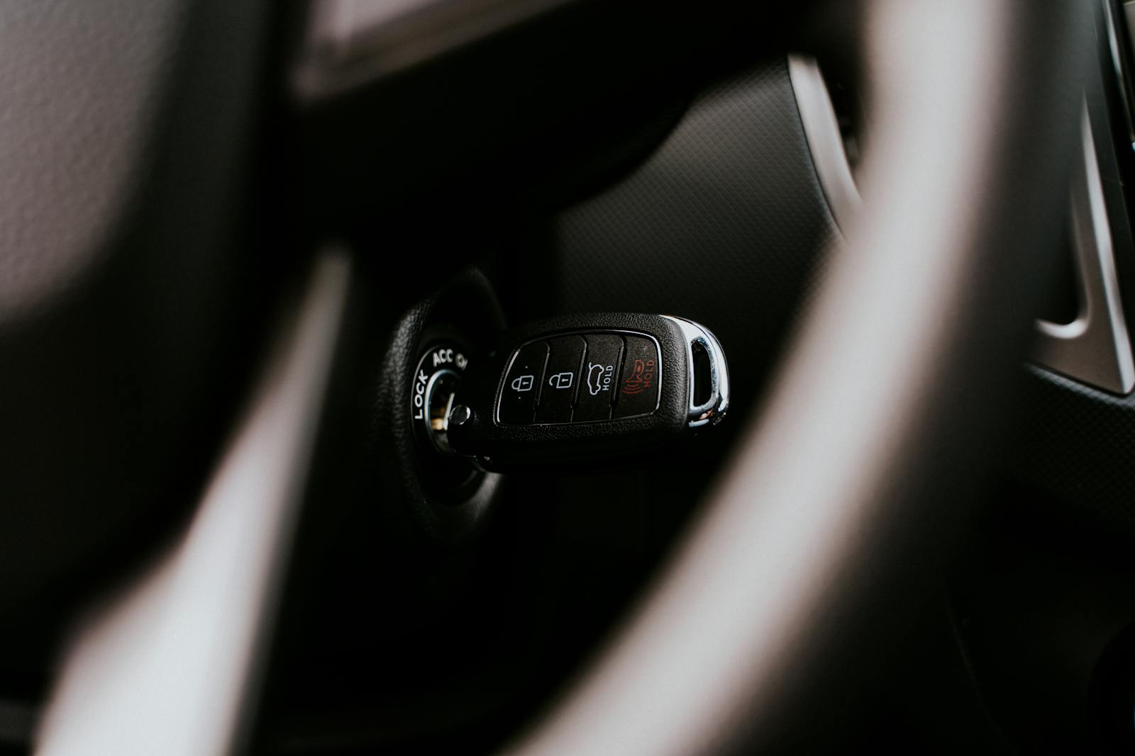 A close-up view of a car key placed in the ignition inside a vehicle, highlighting automotive detail.