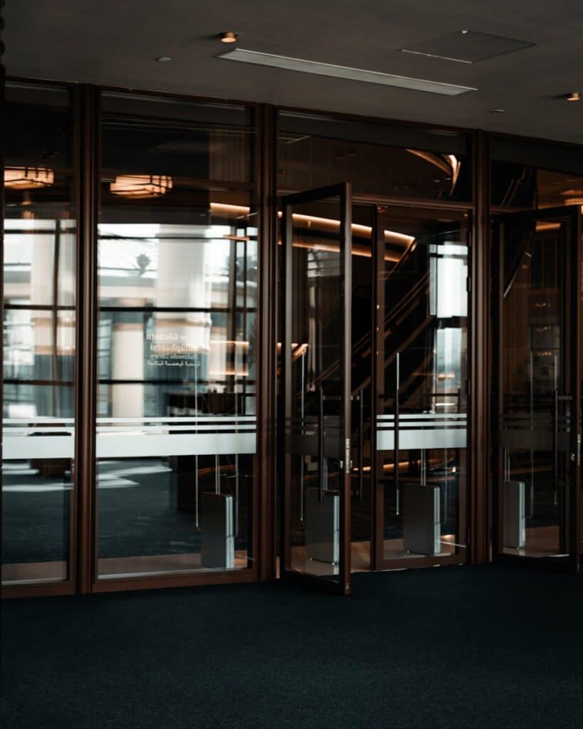 Contemporary glass doors and entrance to a corporate building lobby.