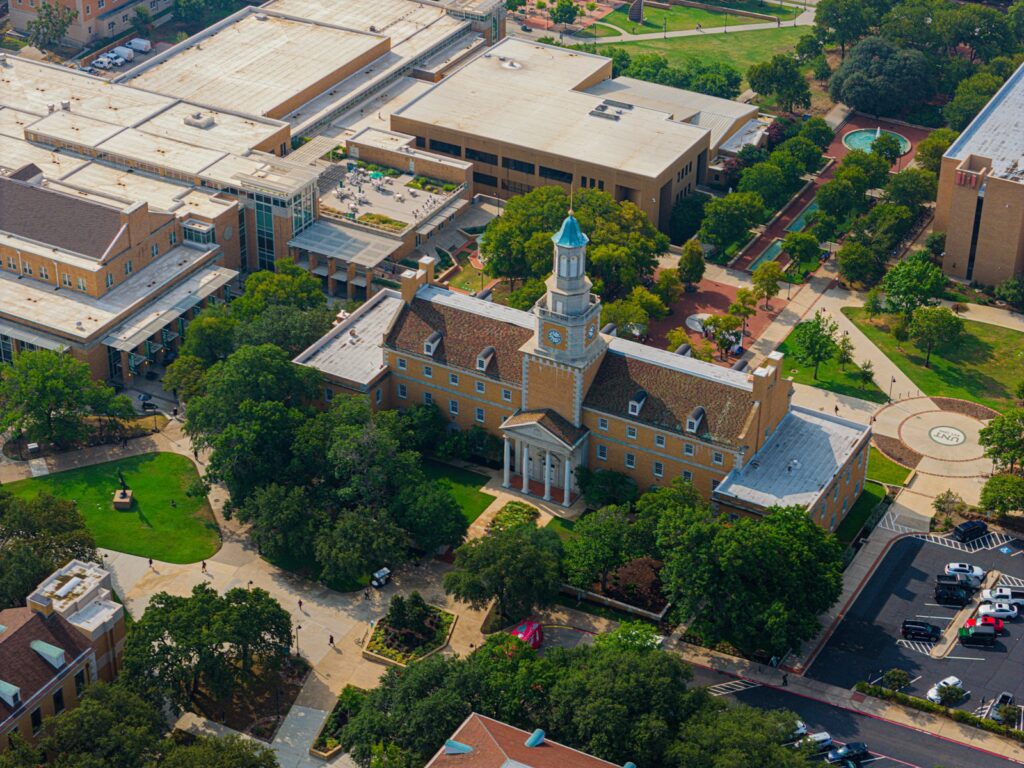 An aerial view of a large building with a clock tower